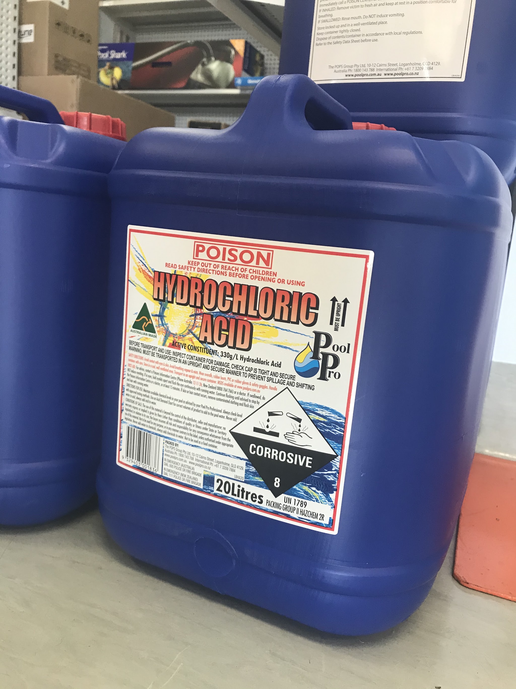Stacked drums of Pool Pro hydrochloric acid in the shop stockroom